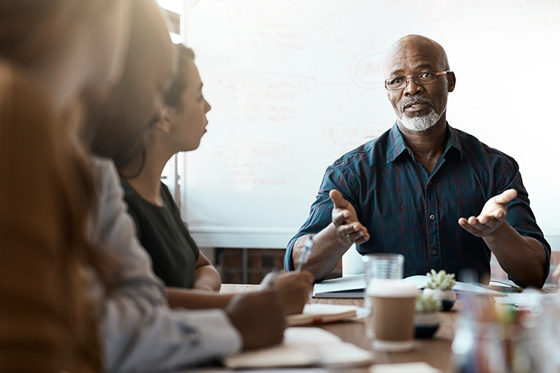 a man leads a meeting in his office