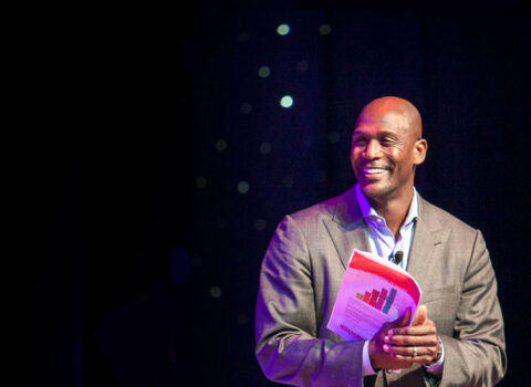 Eric Boles smiling while discussing a graph The Game Changers Inc coaching keynoting training